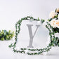 Silver decorative rhinestone letter Y surrounded by flowers.