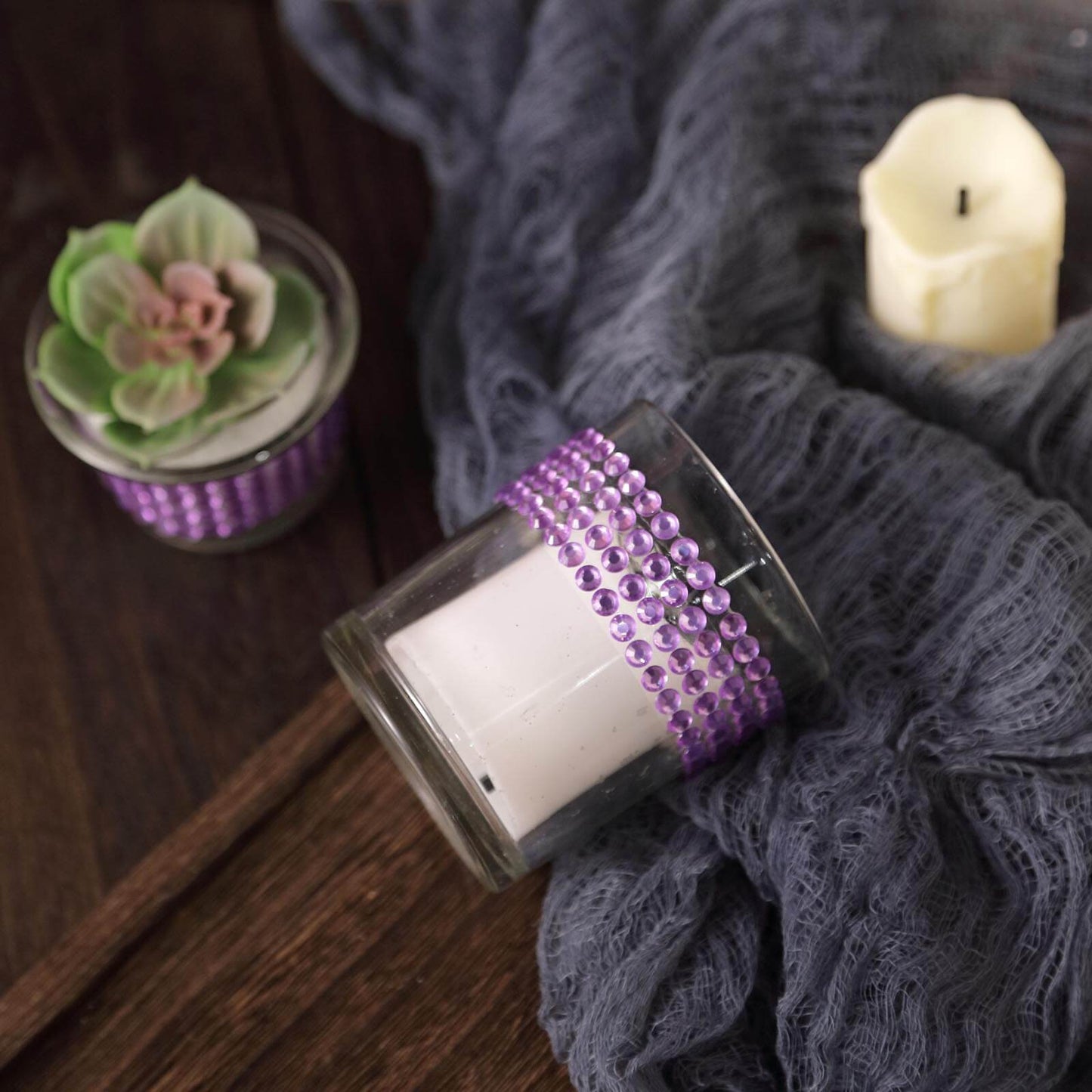 Lavender rhinestone tape applied to decorative candle holders.