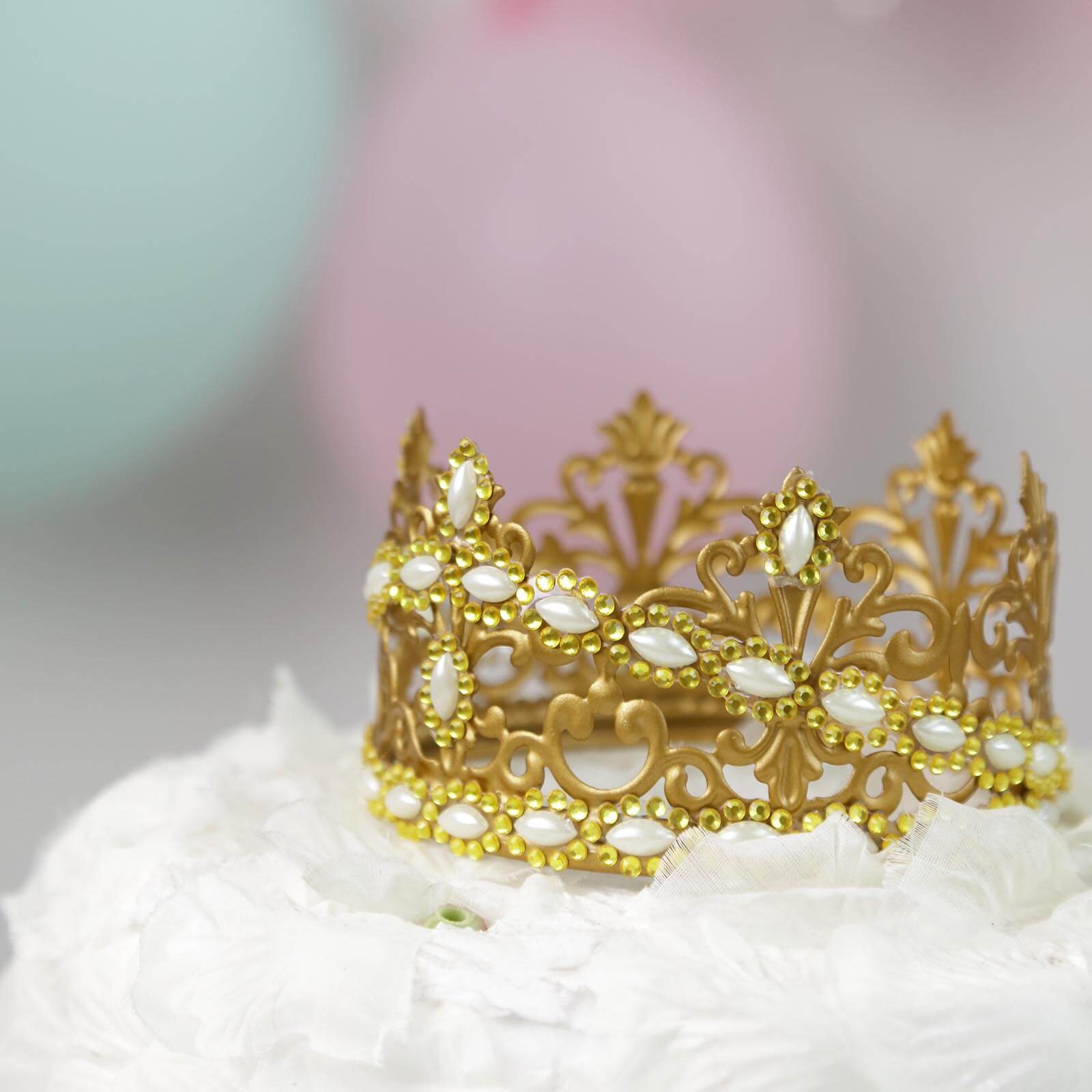 Gold stick-on rhinestone gems in oval shapes for decoration.