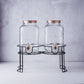 Clear dual gallon glass jars dispenser with rose gold lids.