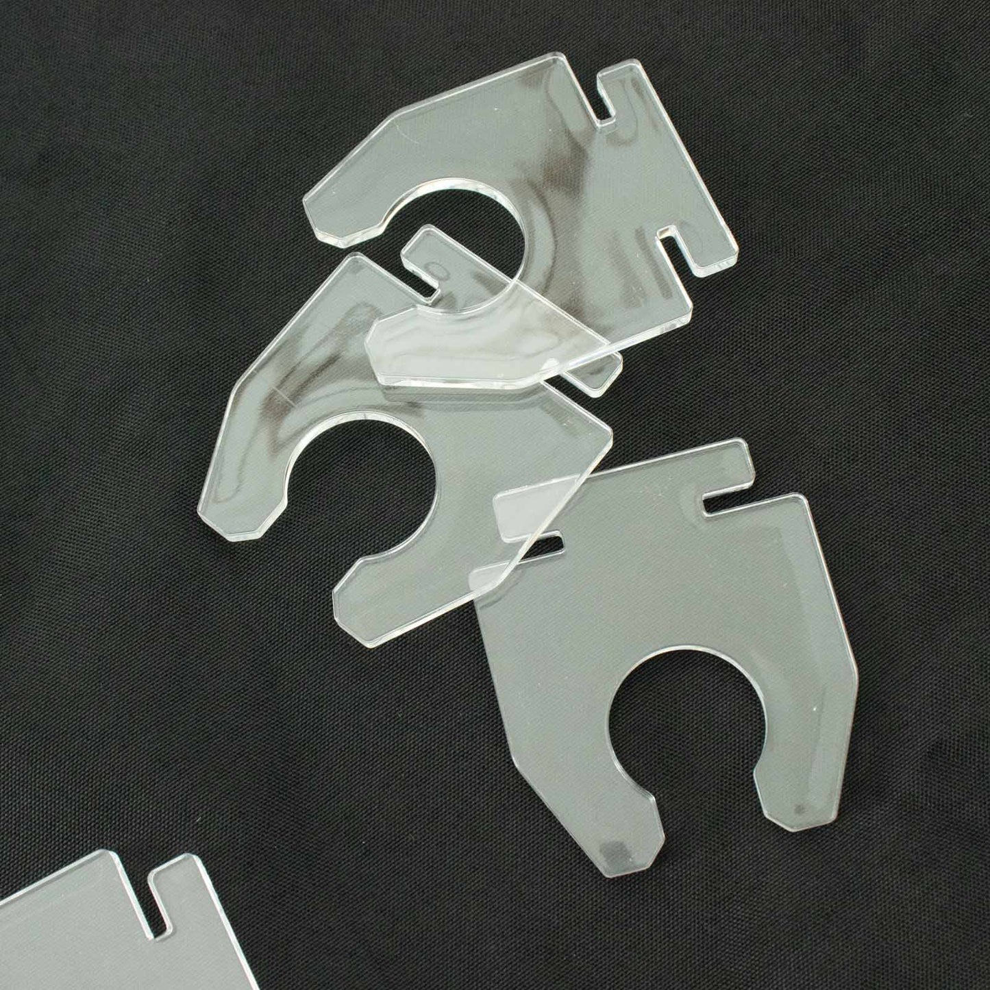 Clear acrylic glass holder hooks for display on champagne rack stand.