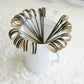 Black eco-friendly loop ring party picks in a white cup.