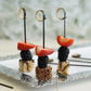 Eco-friendly black loop ring party picks with fruit on a decorative platter.