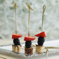Eco-friendly twisted knot cocktail sticks with decorative tops on a platter.