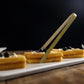 Eco-friendly natural bamboo tongs on a platter with waffles and blueberries.