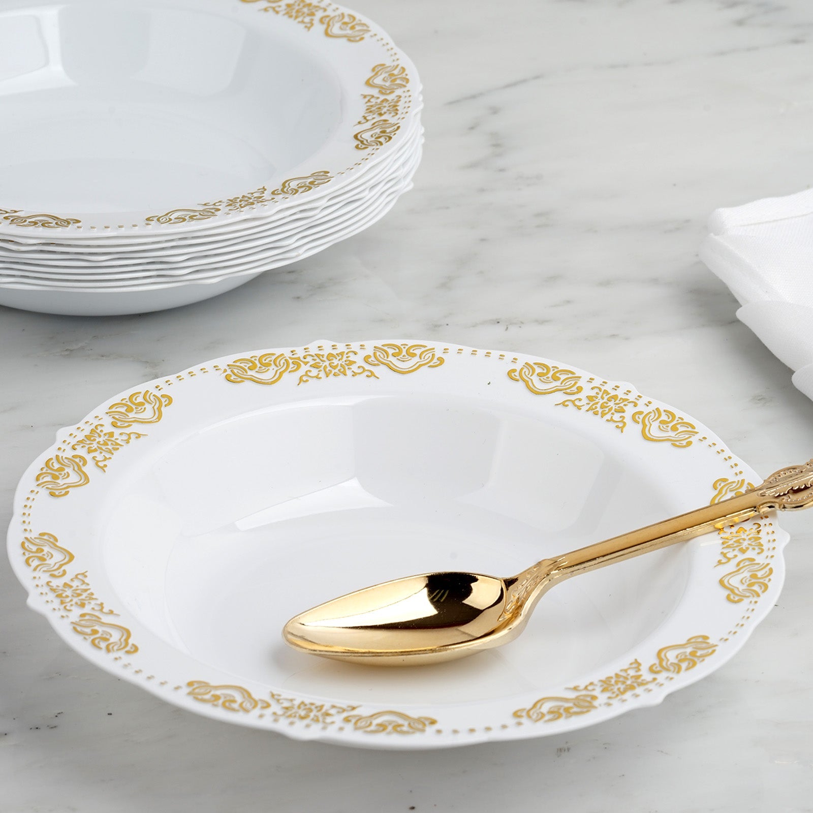 Gold embossed white disposable soup bowl with scalloped edges.