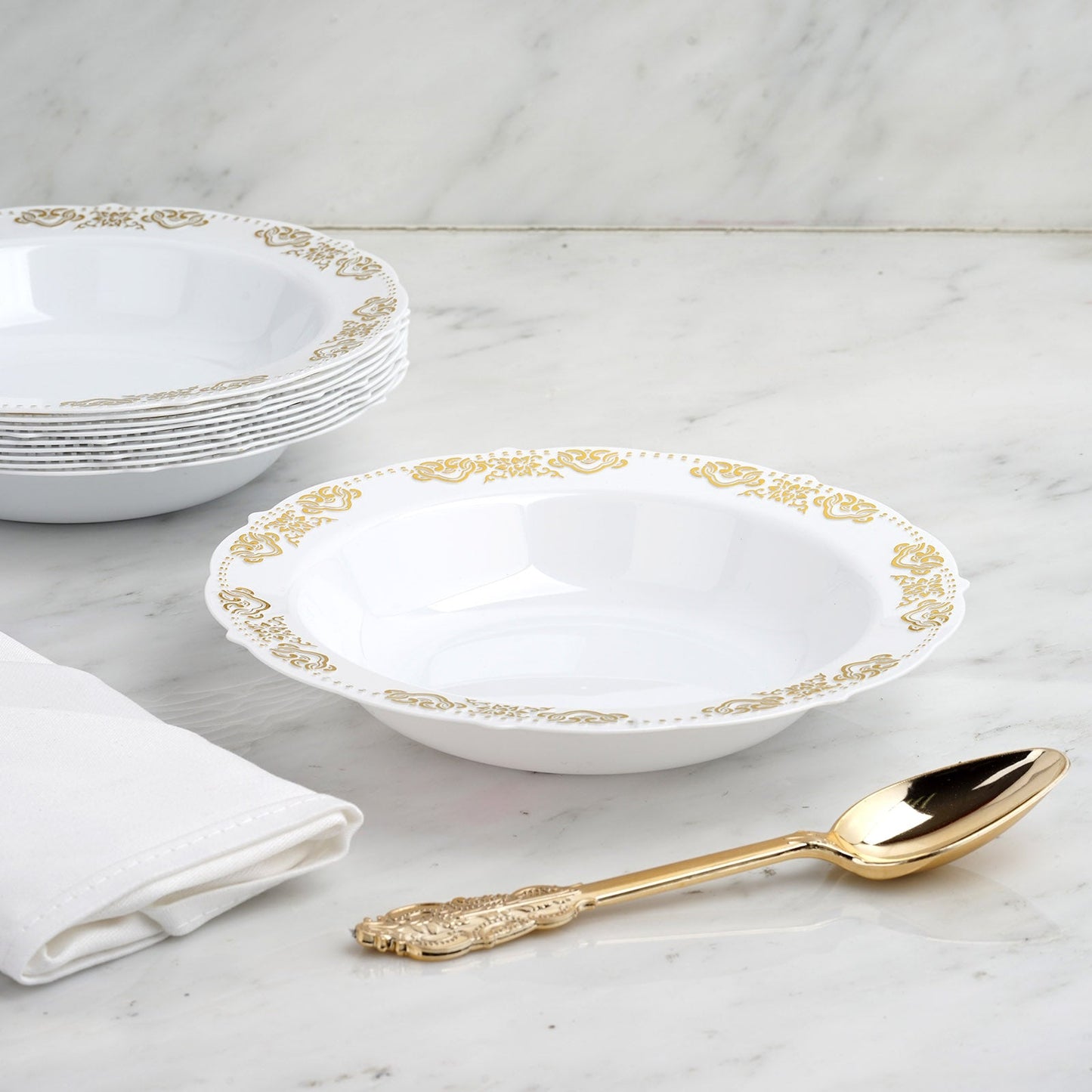 Gold embossed white disposable soup bowl with scalloped edges.
