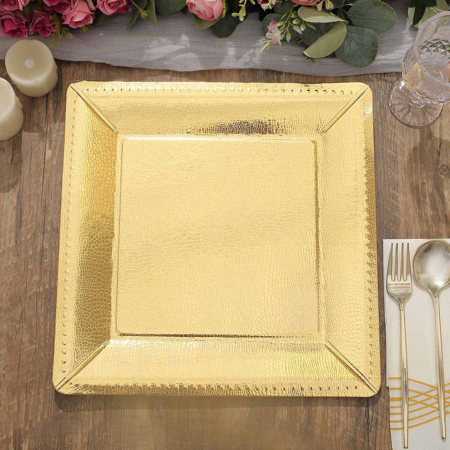 Gold textured disposable square serving tray on a wooden table.