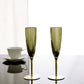 Metallic gold disposable champagne flutes on a table.