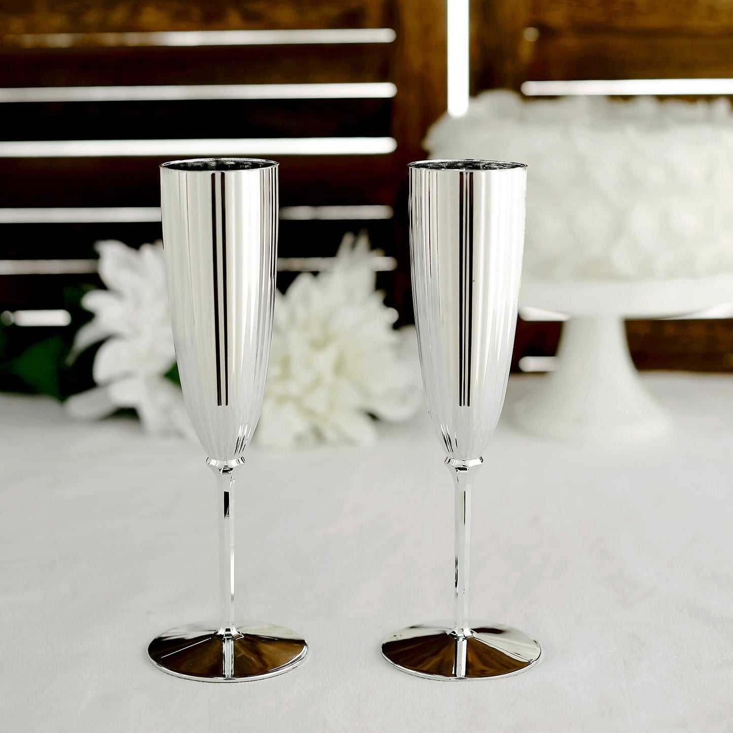 Silver plastic champagne flutes, 5oz, disposable glasses for celebrations.