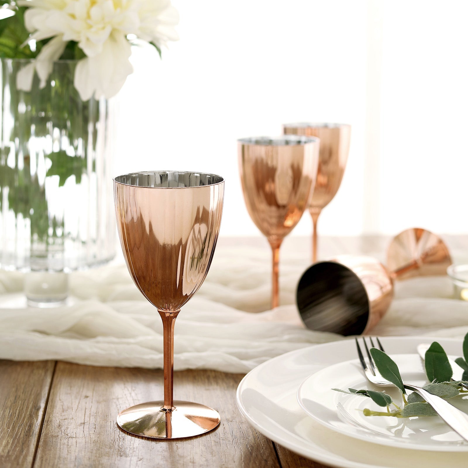 Rose gold disposable wine glasses in a stylish setting.