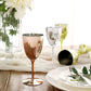 Silver disposable wine glasses in a stylish setting.