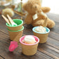 Colorful reusable ice cream cone bowls and spoons in blue, green, and pink.