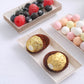 Biodegradable mini rectangular dessert plates with snacks, in light beige.