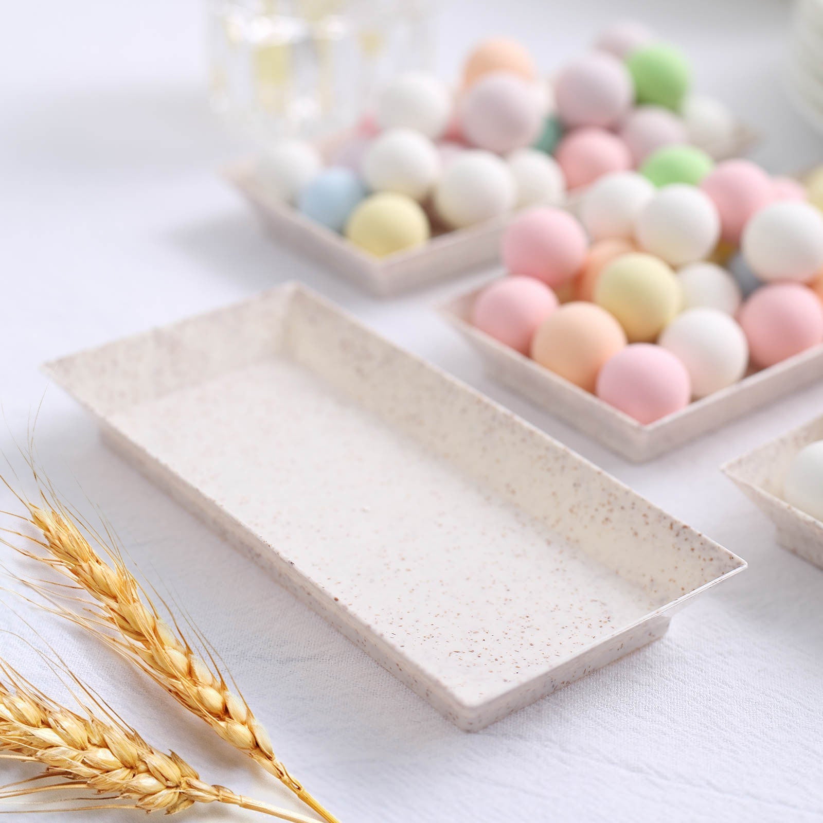 Biodegradable mini rectangular dessert plates in a natural wheat color.