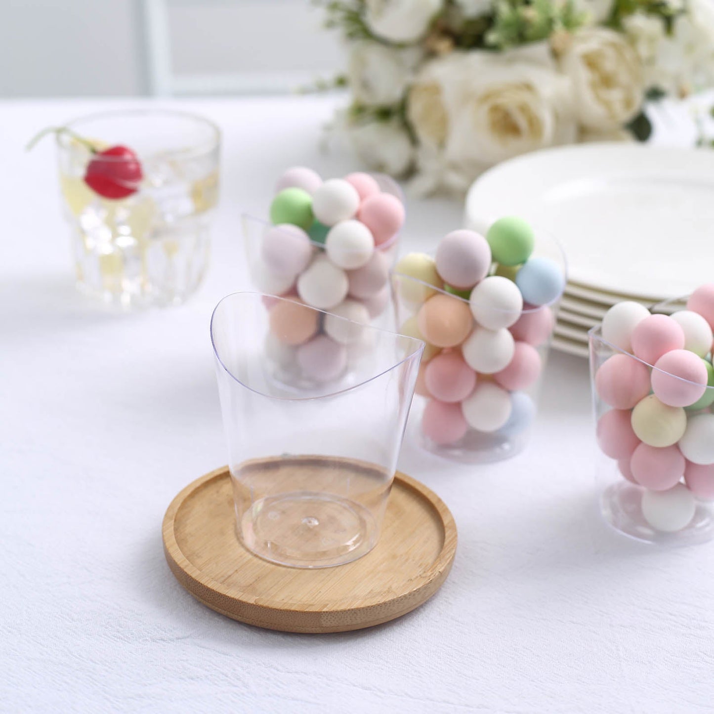 Clear mini wavy rim disposable dessert cup with pastel candy balls.