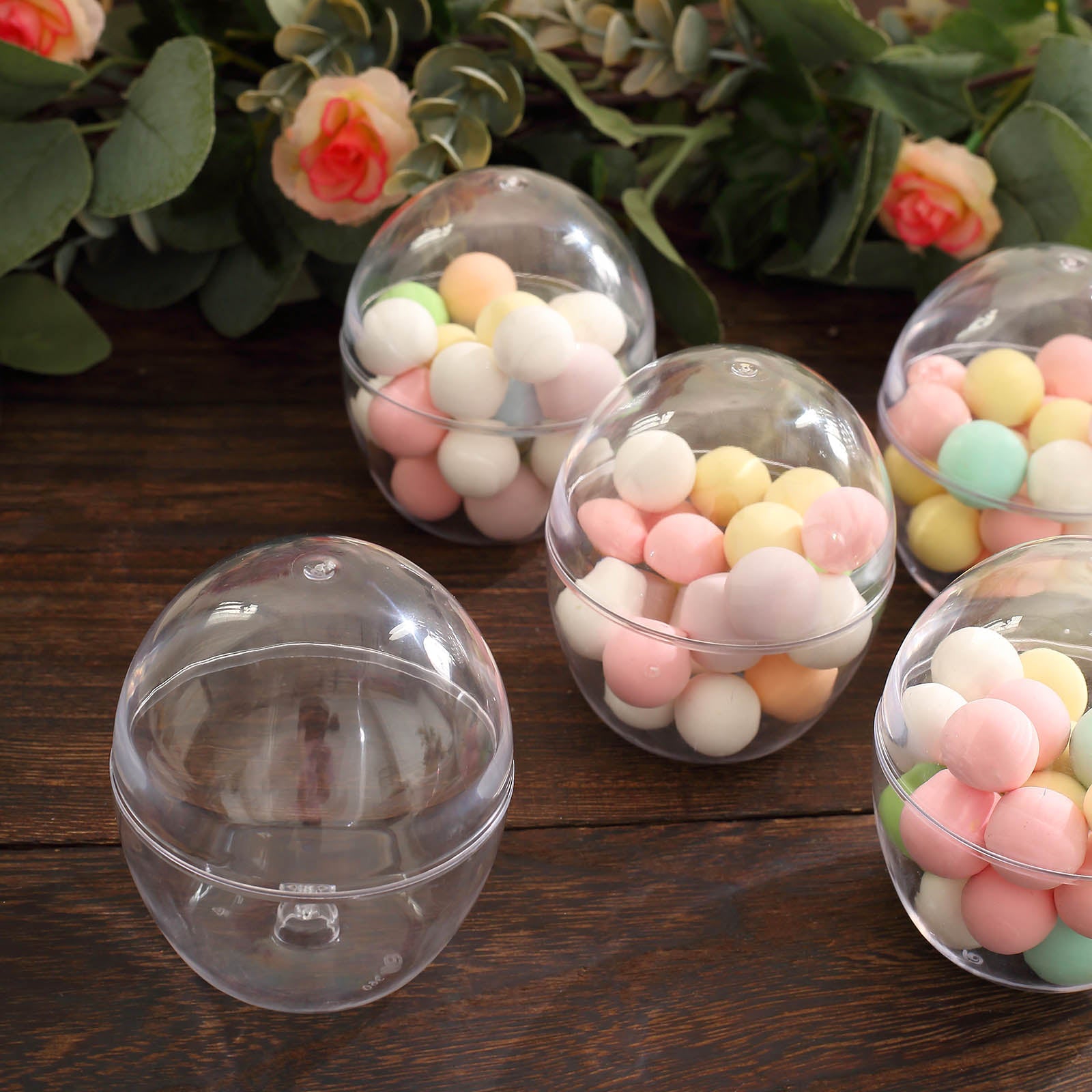 Clear mini egg-shaped candy favor cup containers with dome lids.