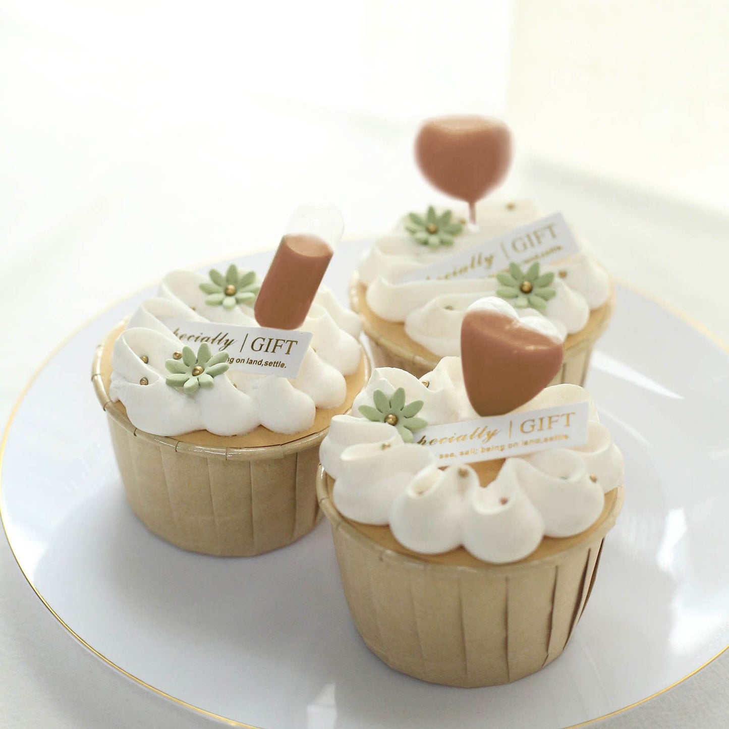 Clear plastic dessert topper pipettes on cupcakes, perfect for festive occasions.
