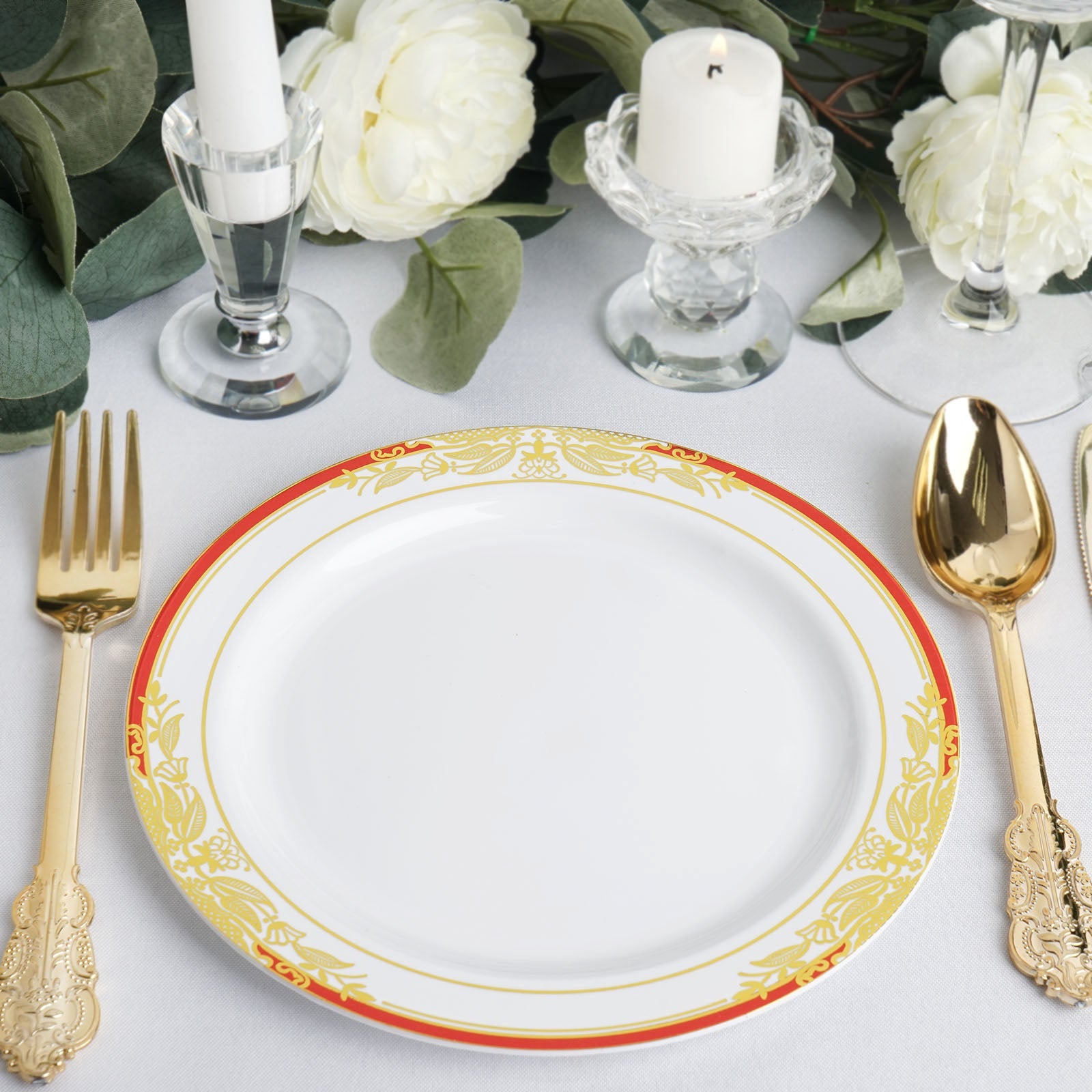 White plate with red rim and gold vine design, perfect for appetizers and salads.