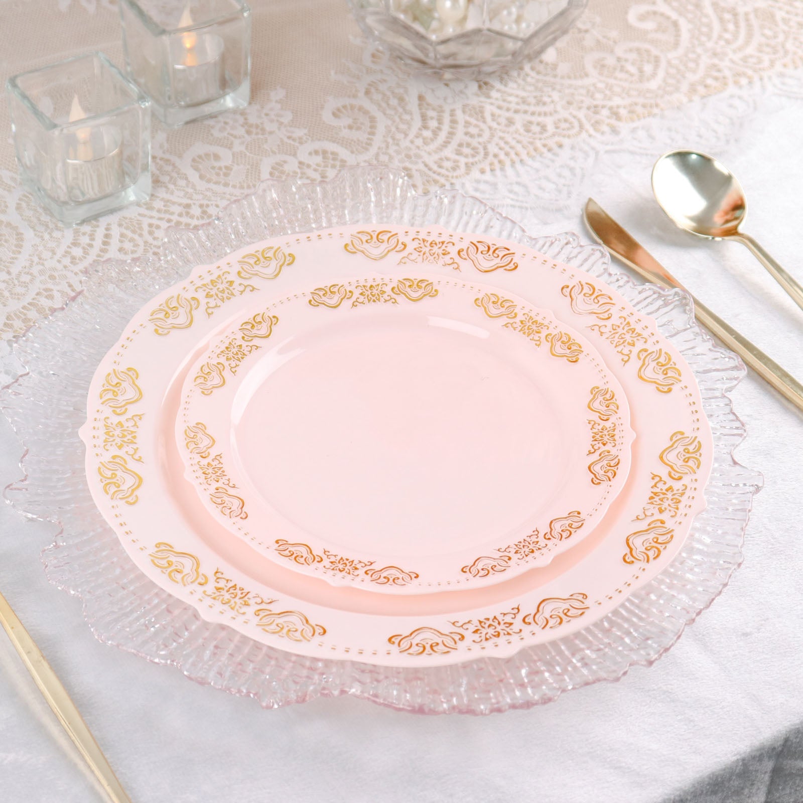 Gold embossed blush plastic dinner plates with scalloped edges.