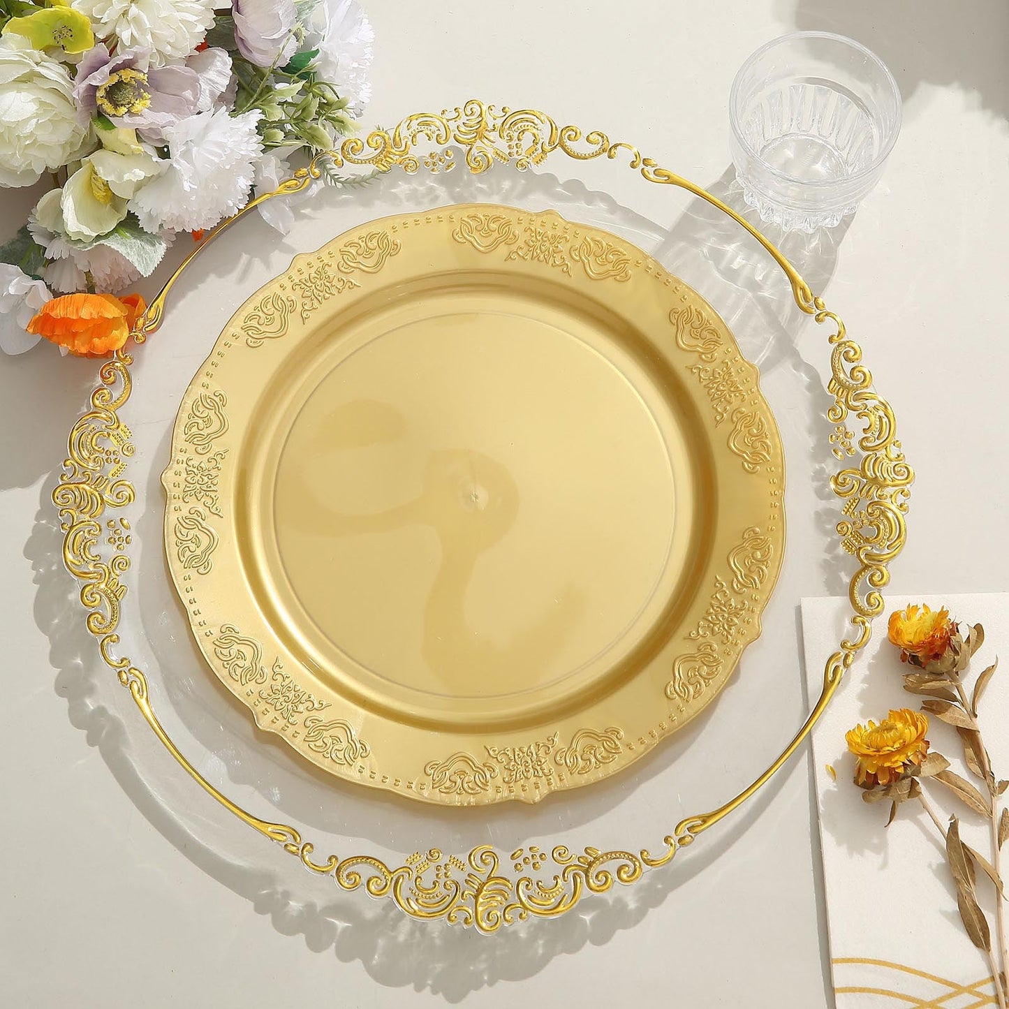 Gold embossed hard plastic round dinner plate with scalloped edges.
