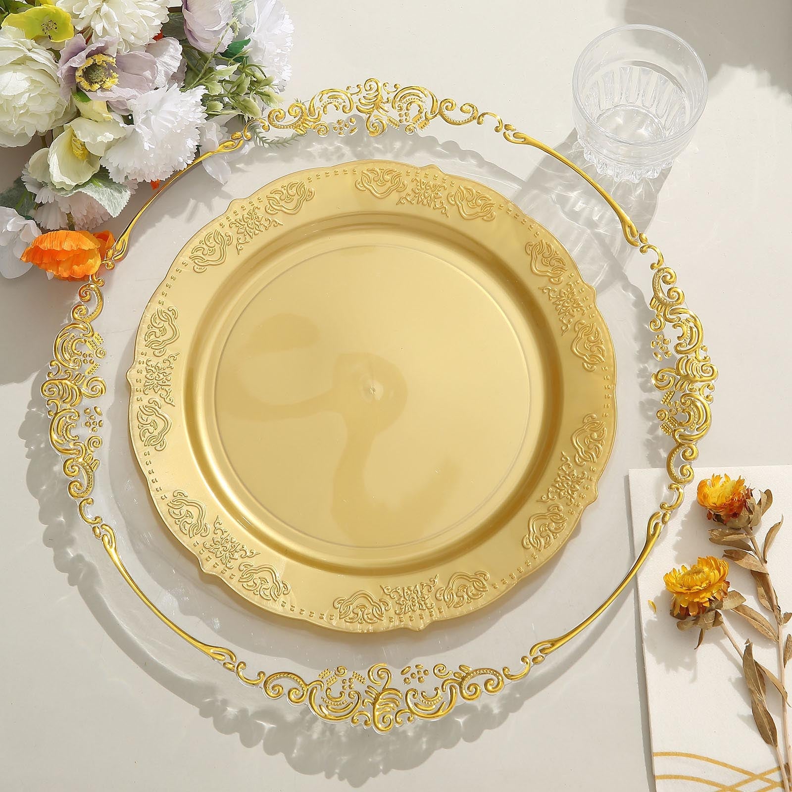 Gold embossed hard plastic round dinner plate with scalloped edges.