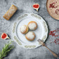 Gold embossed white dinner plate with scalloped edges, serving pastries.