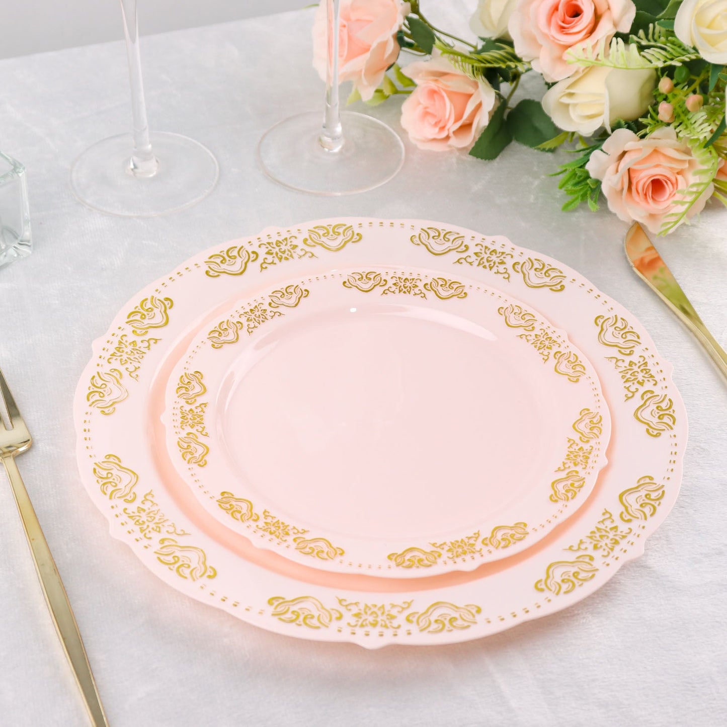 Gold embossed blush plastic appetizer plates with scalloped edges.