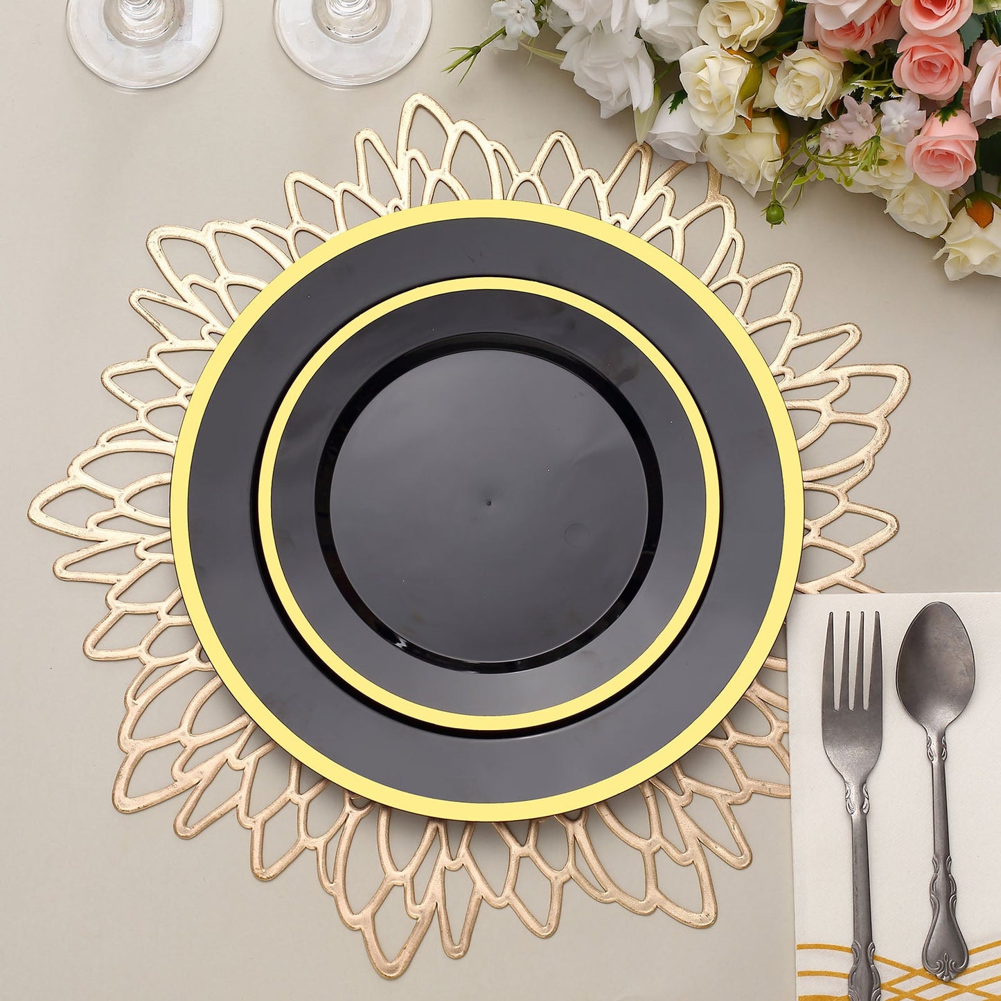 7" Regal Black and Gold Round Plastic Dessert Plates on a decorative charger.