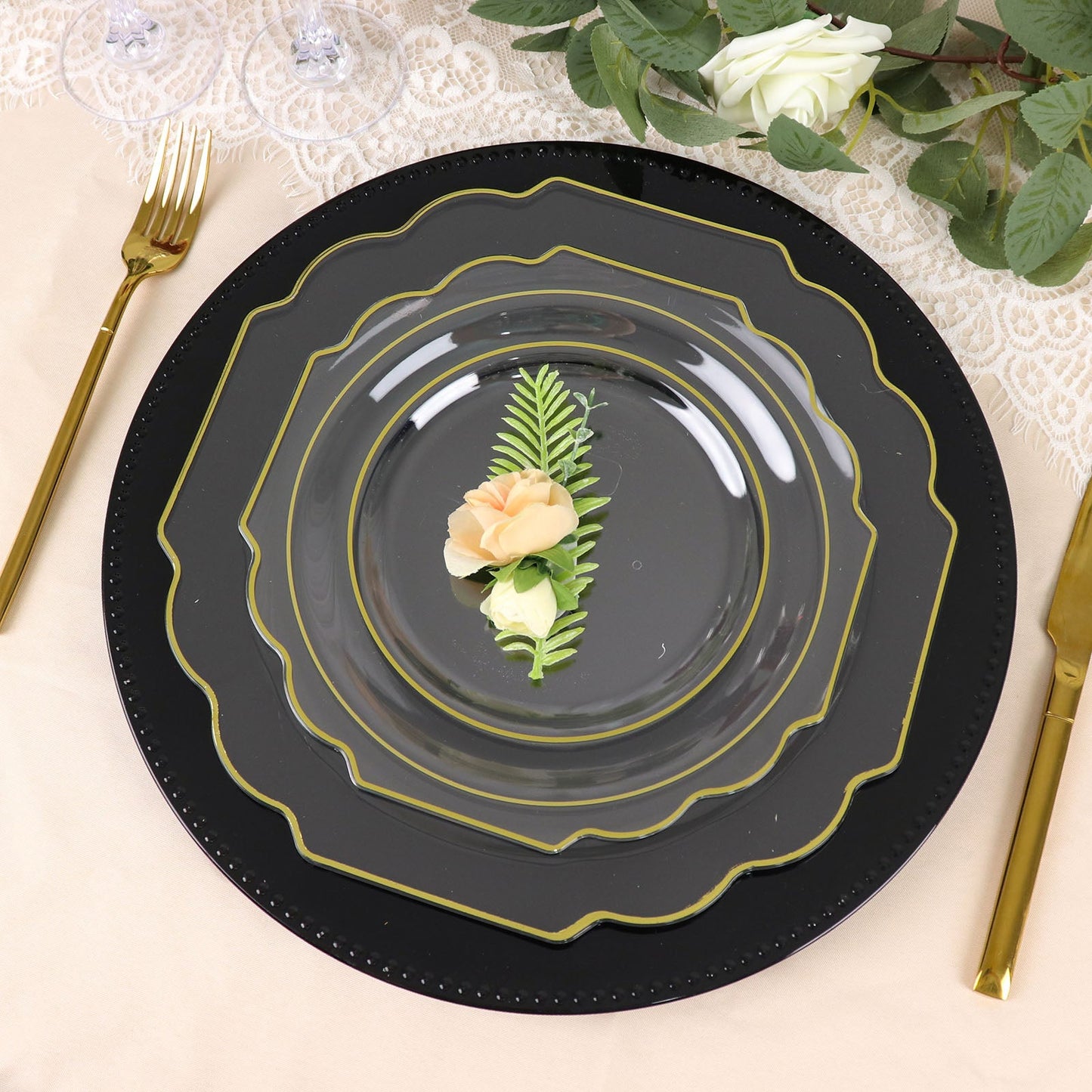 Clear hard plastic dessert plates with gold rim on a black background.