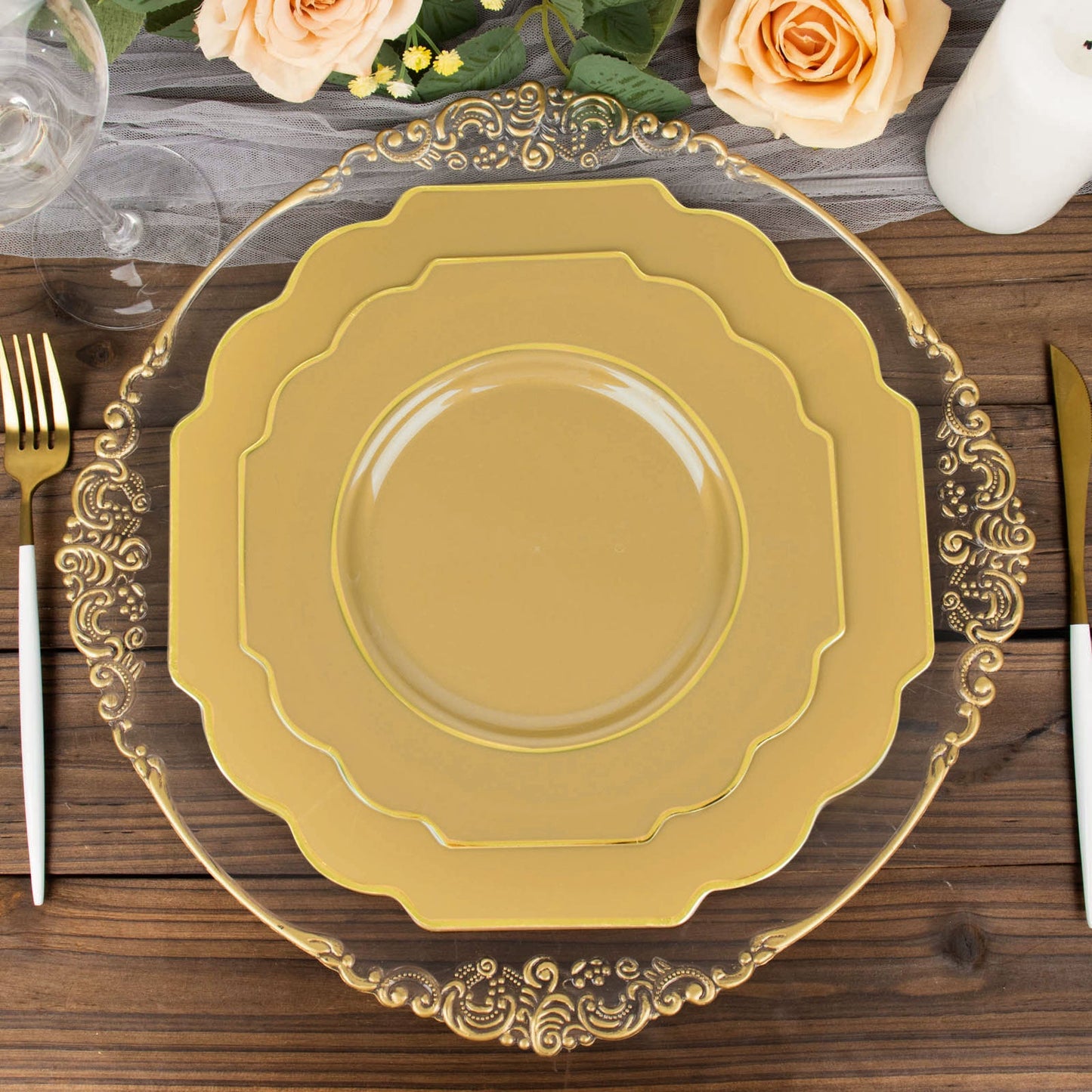 Gold hard plastic dessert plates with decorative rim on a wooden table.
