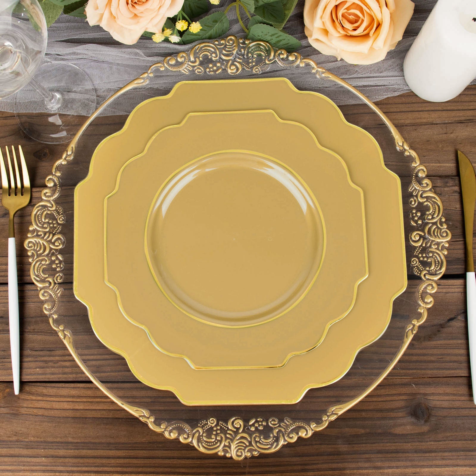 Gold hard plastic dessert plates with decorative rim on a wooden table.