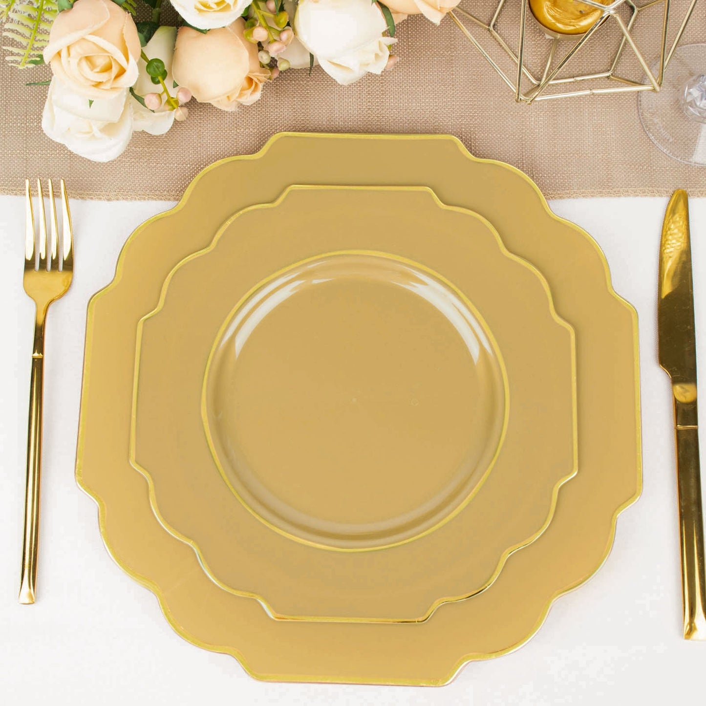 Gold disposable Baroque dessert plates with gold rim on a table setting.