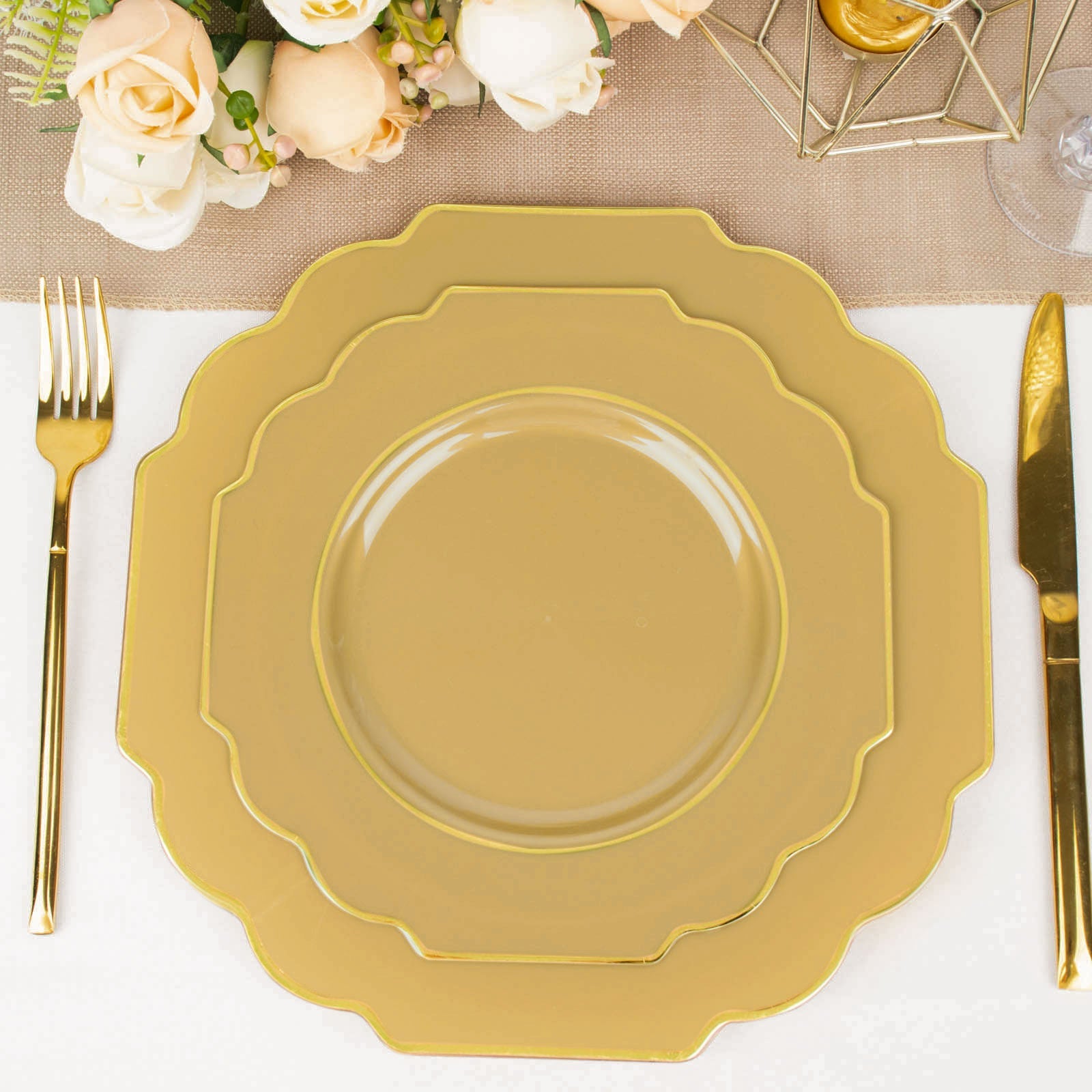Gold disposable Baroque dessert plates with gold rim on a table setting.