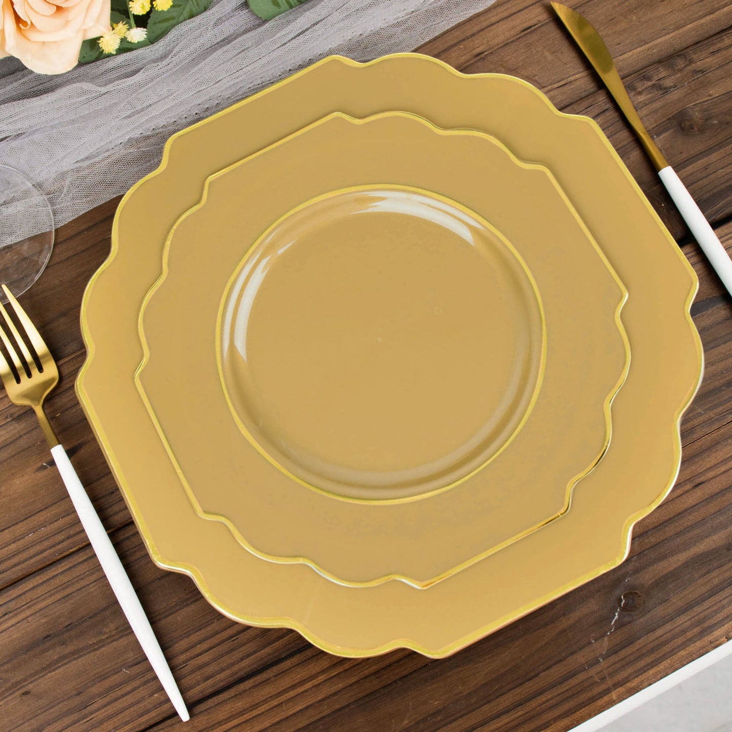 Gold disposable Baroque dessert plates with decorative rim.