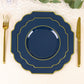 Navy blue dessert plates with gold rim on a table setting.
