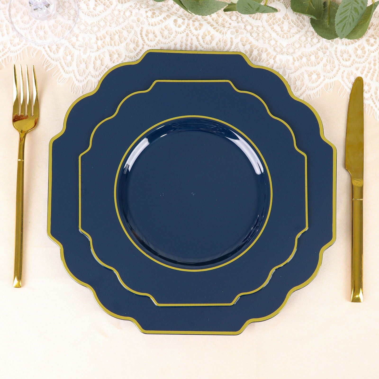 Navy blue dessert plates with gold rim on a table setting.