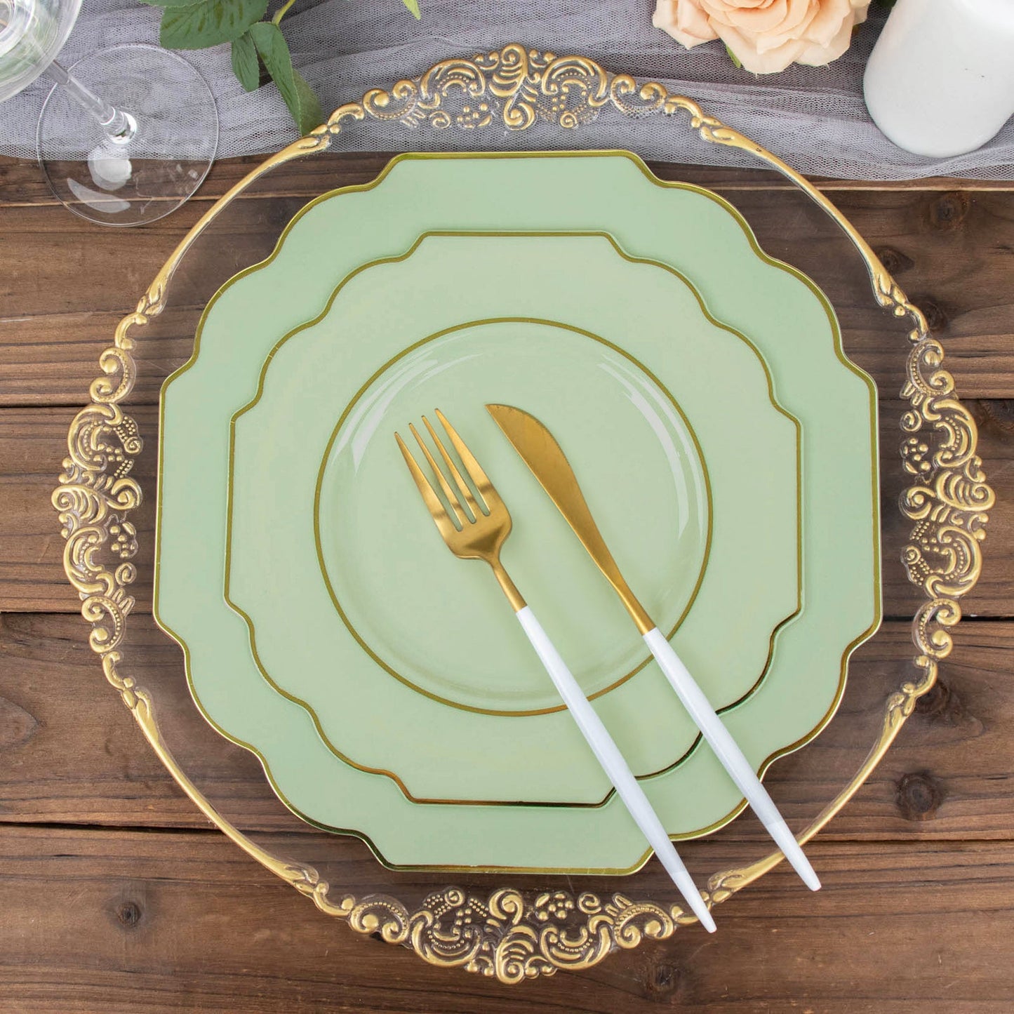Sage green dessert plates with gold rim on a wooden table setting.
