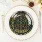 Navy blue geometric gold print disposable plastic plates set on a table.