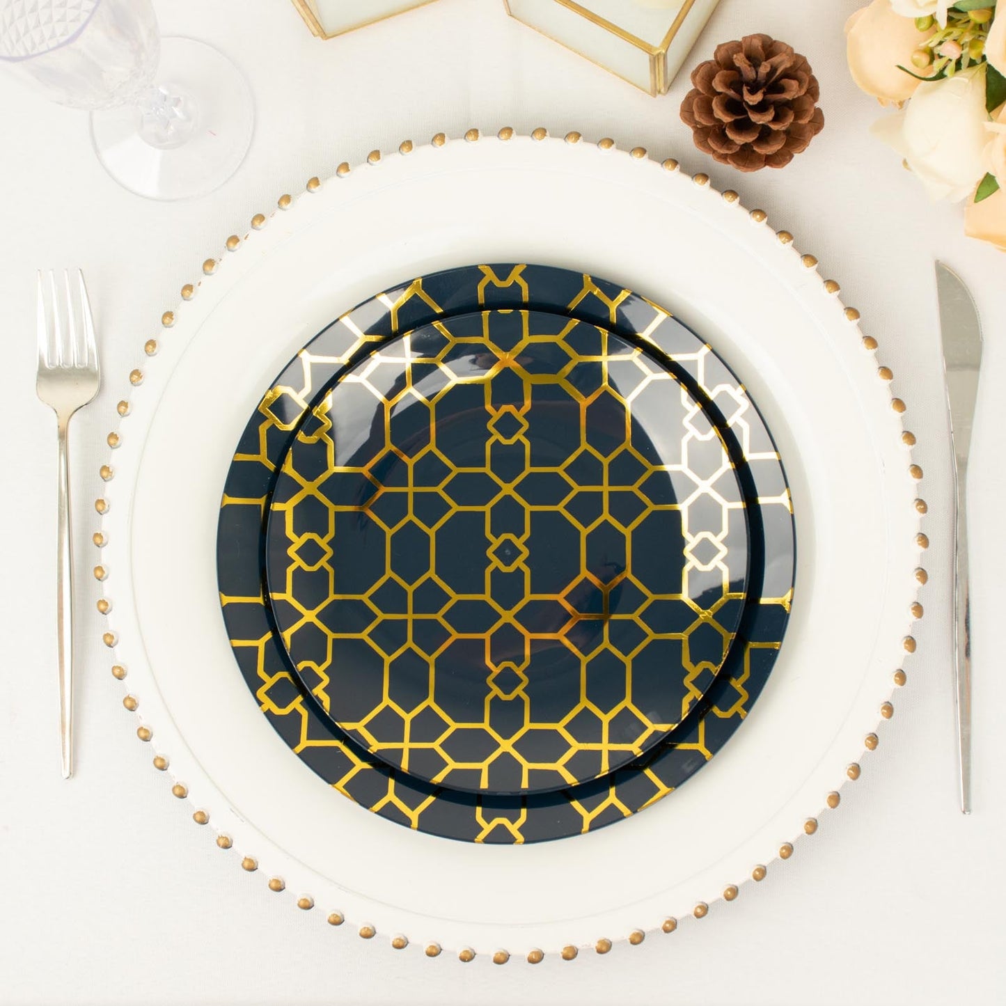 Navy blue geometric gold print disposable plastic plates set on a table.