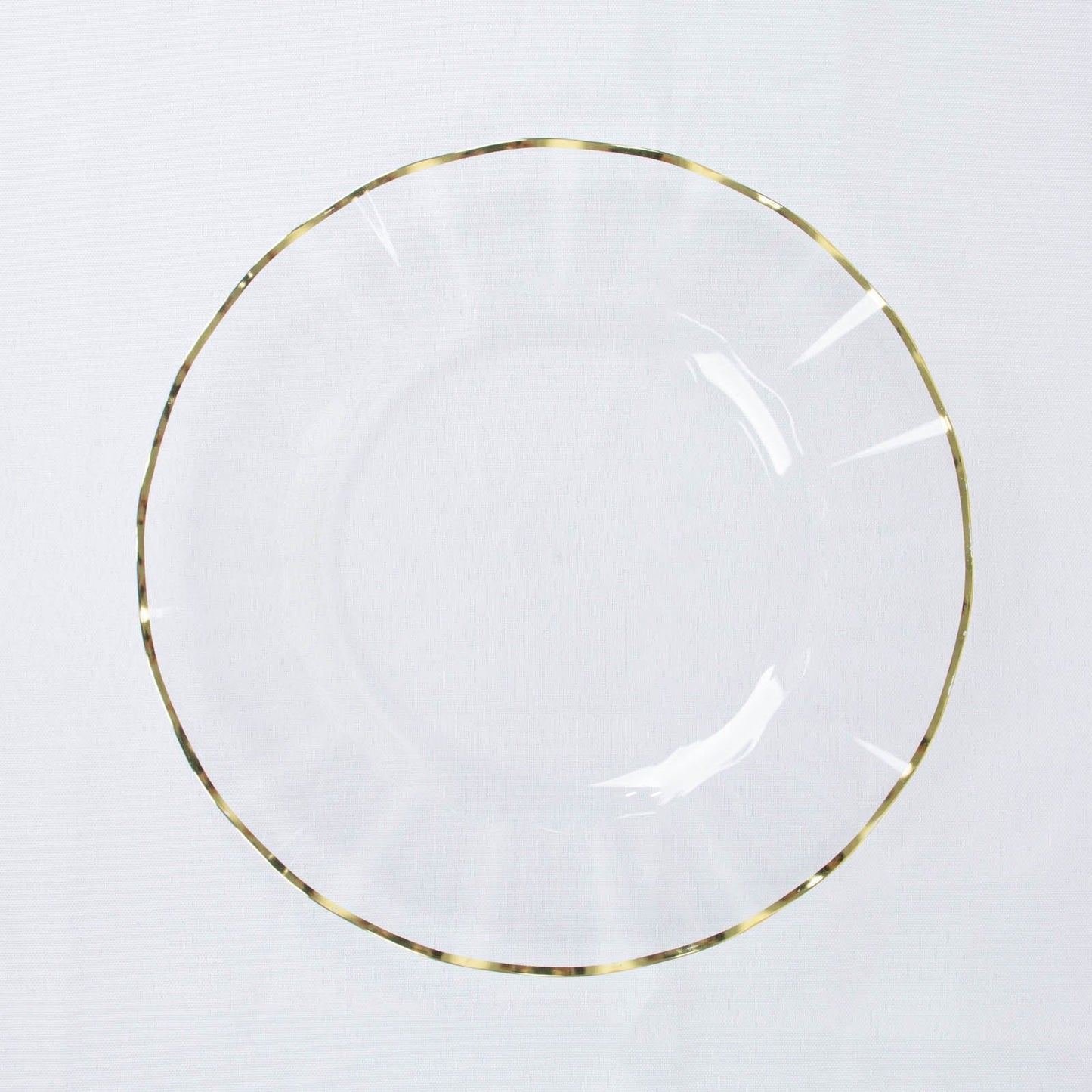 Clear hard plastic dinner plate with gold ruffled rim.
