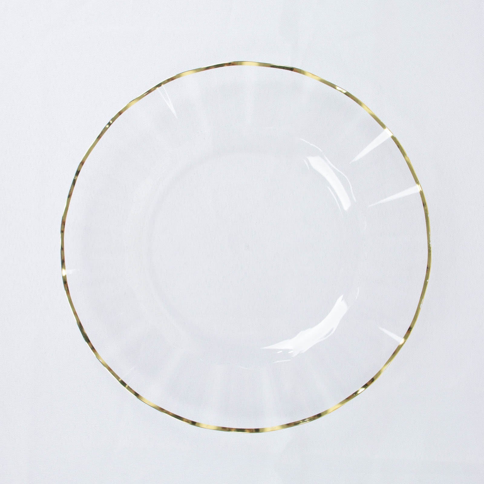 Clear hard plastic dinner plate with gold ruffled rim.