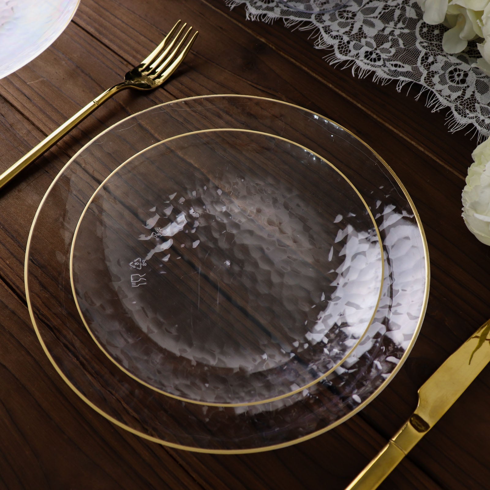 Clear hammered round plastic dessert plates with gold rim.