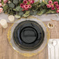 Elegant black plate on a gold-trimmed charger with candles and floral arrangement.