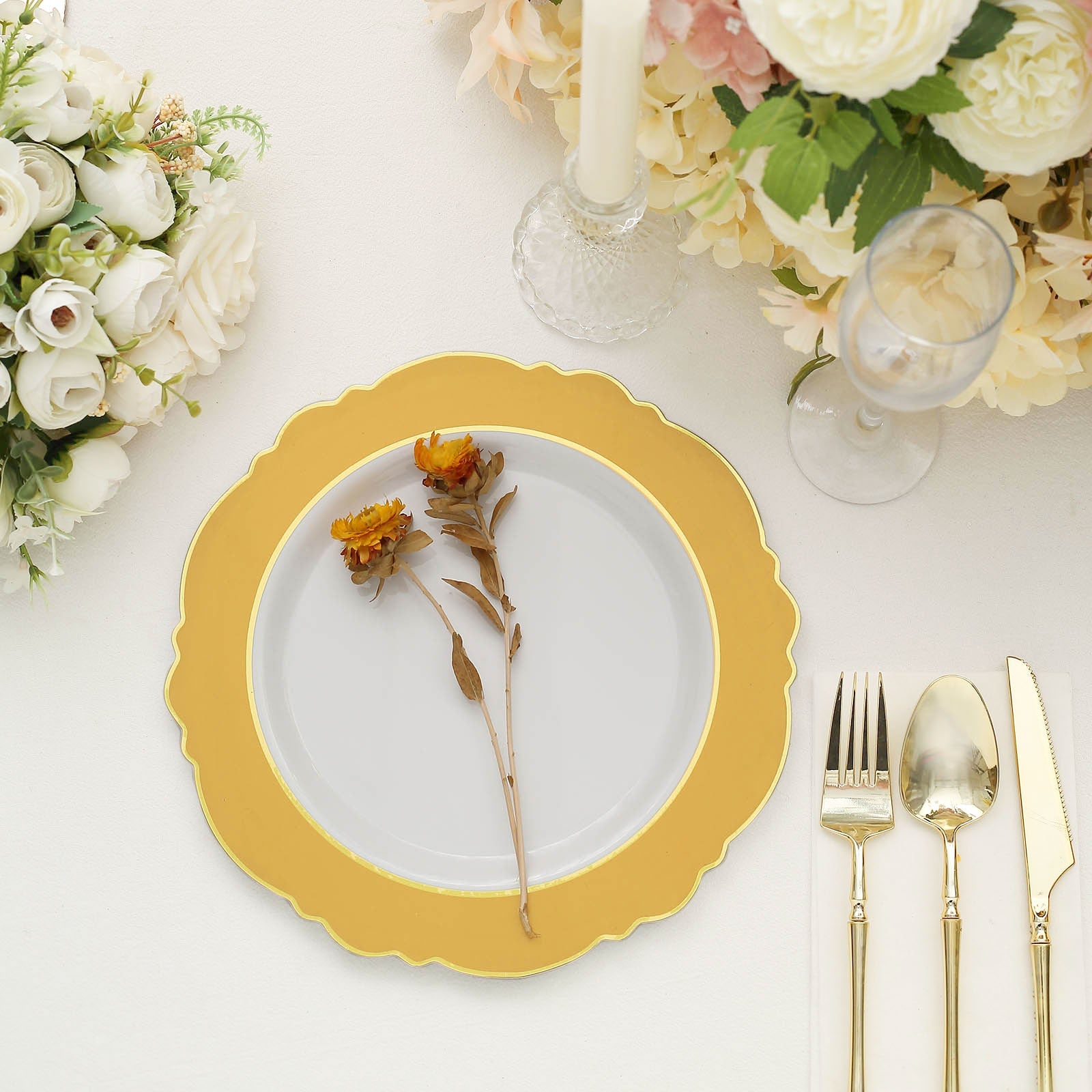 Gold and white disposable dinner plate with round blossom design.