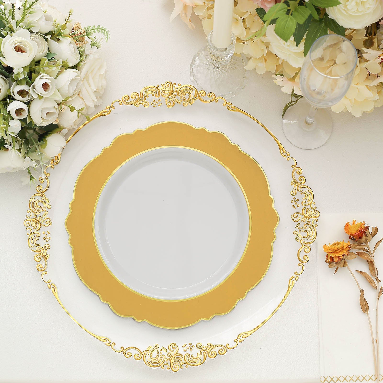 Gold and white disposable dinner plate with round blossom design.