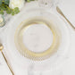 Clear plastic party plate with gold swirl rim on a marble surface.
