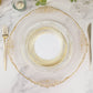 White plastic party plates with gold swirl rim on a marble table.