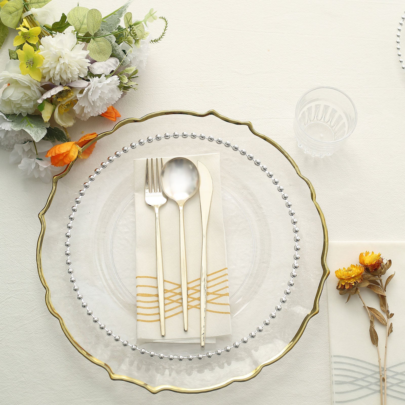 Clear plastic dinner plate with silver beaded rim, perfect for festive occasions.