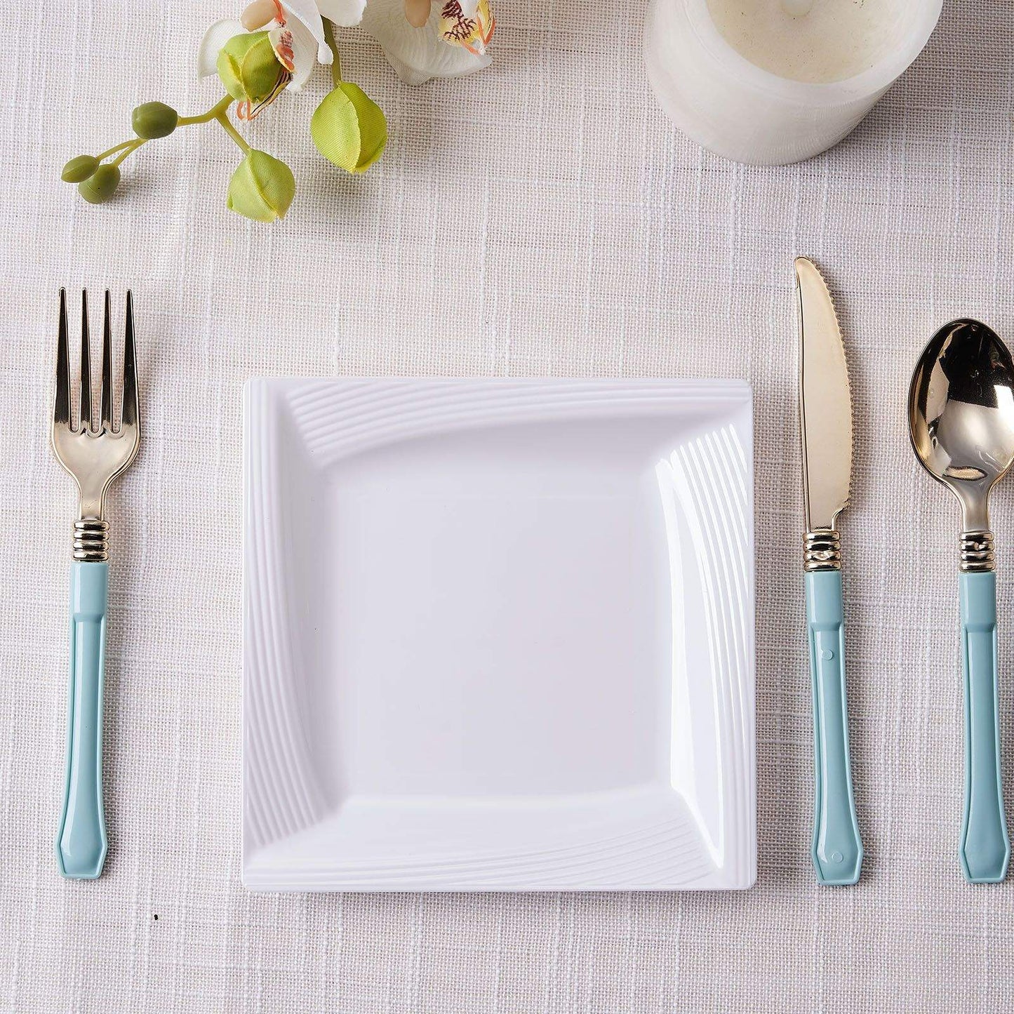 White square geometric ridge trim plastic salad plate on a table setting.